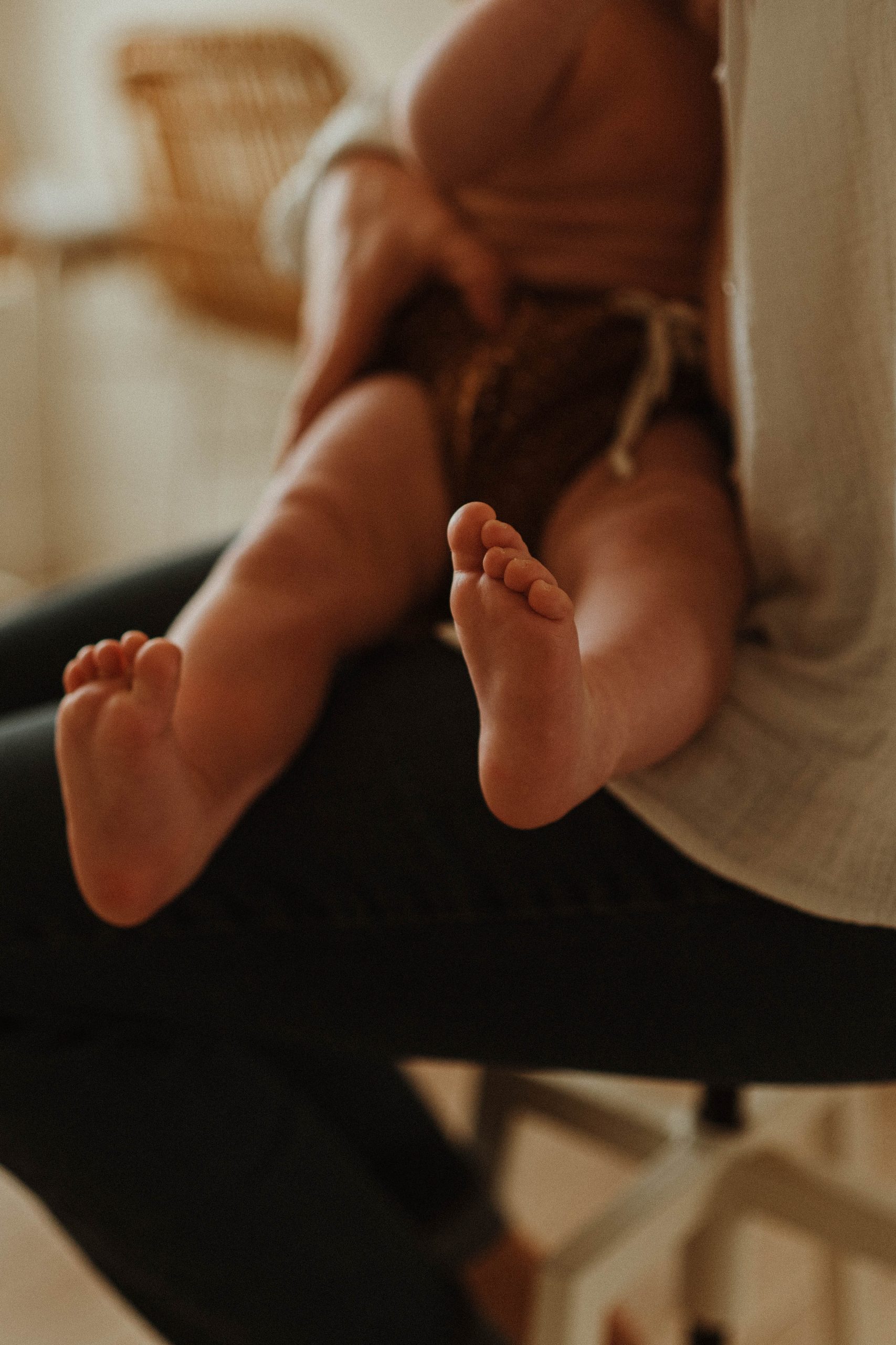 Parent tenant les pieds de son bébé